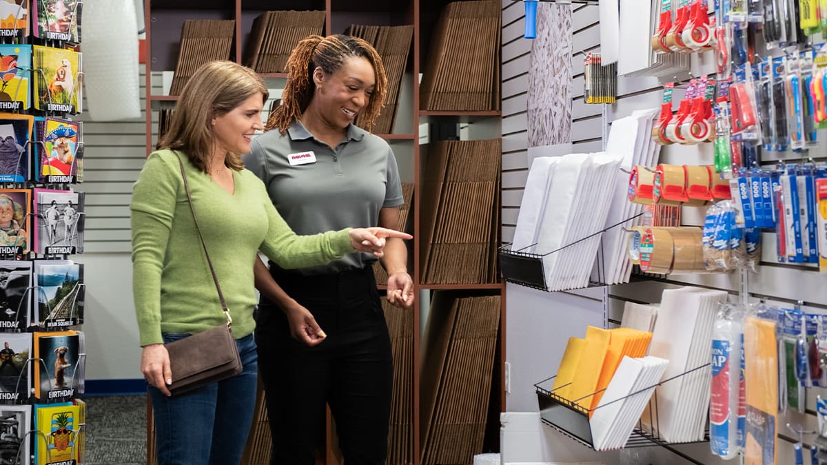 Pak Mail team member helping a customer choose mailing supplies.